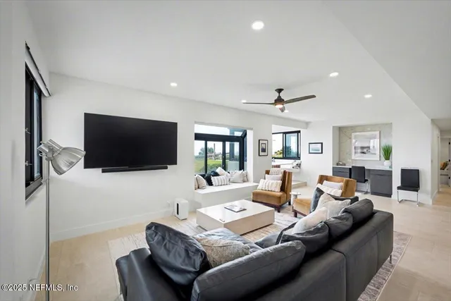 a view of a house with a large tree and a yard in front of it