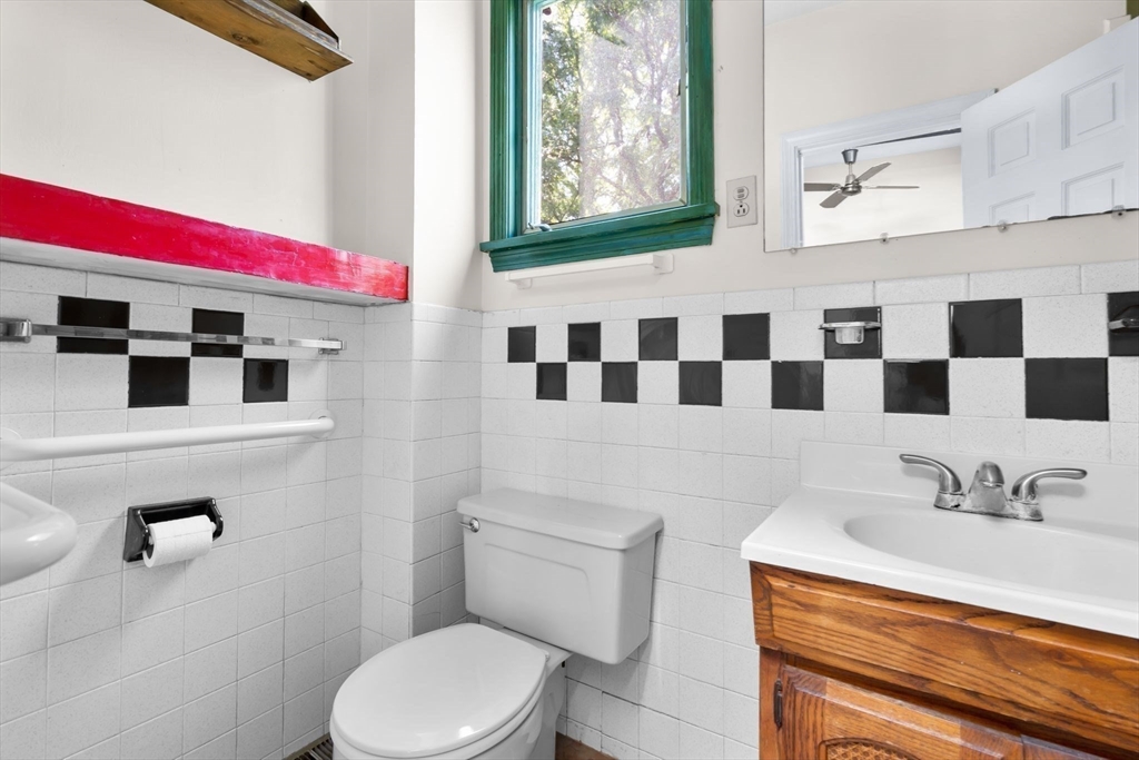 2 Livermore Place Cambridge, MA 02141 - Photo 15 of 20 a bathroom with a sink a toilet and a mirror