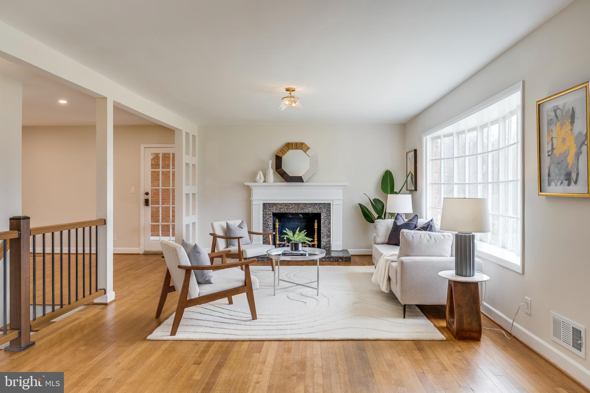15001 Peach Orchard Road Silver Spring, MD 20905 - Photo 1 of 63 a living room with furniture a fireplace and a table