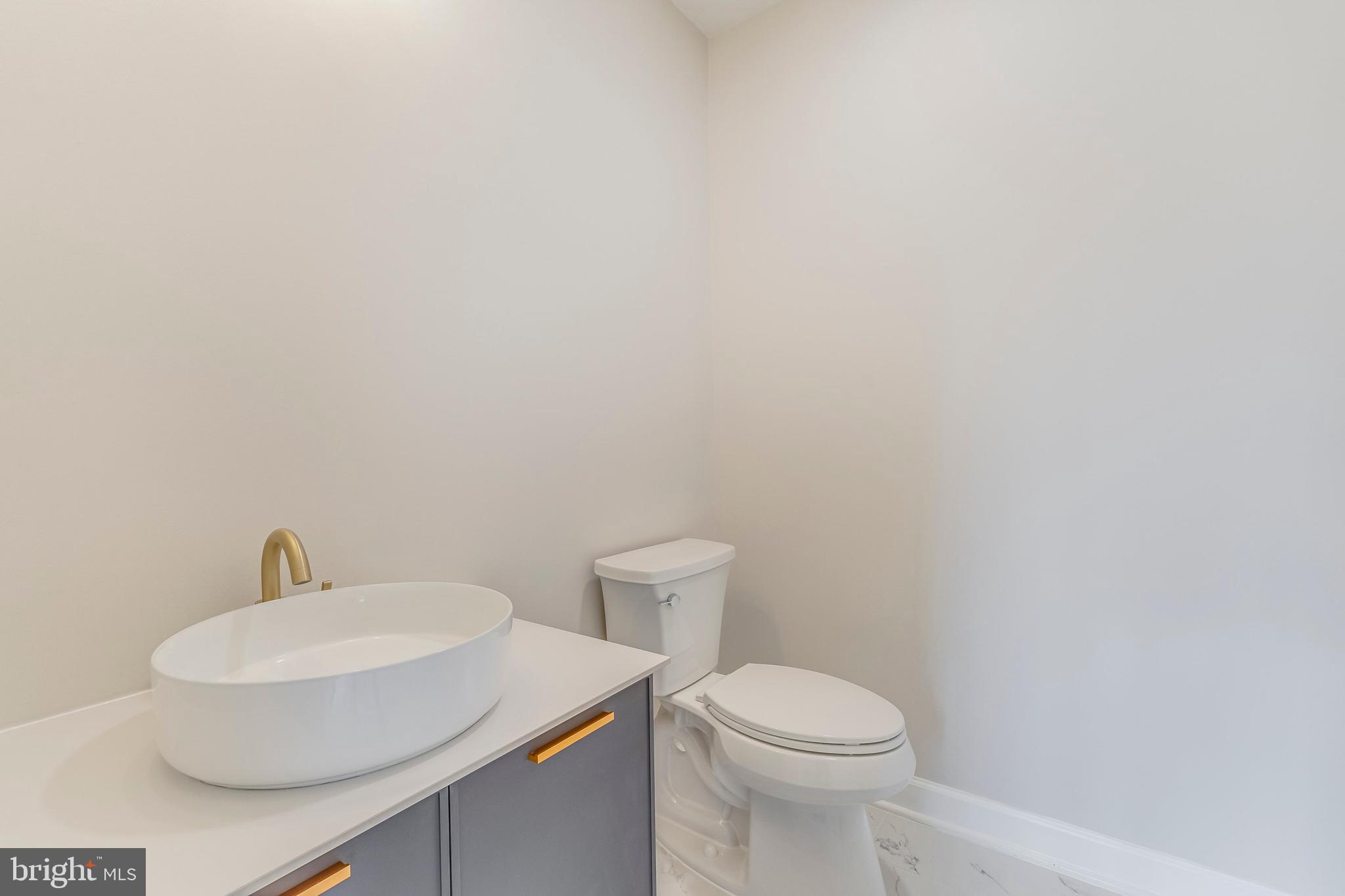 15001 Peach Orchard Road Silver Spring, MD 20905 - Photo 11 of 63 a white toilet sitting next to a white sink