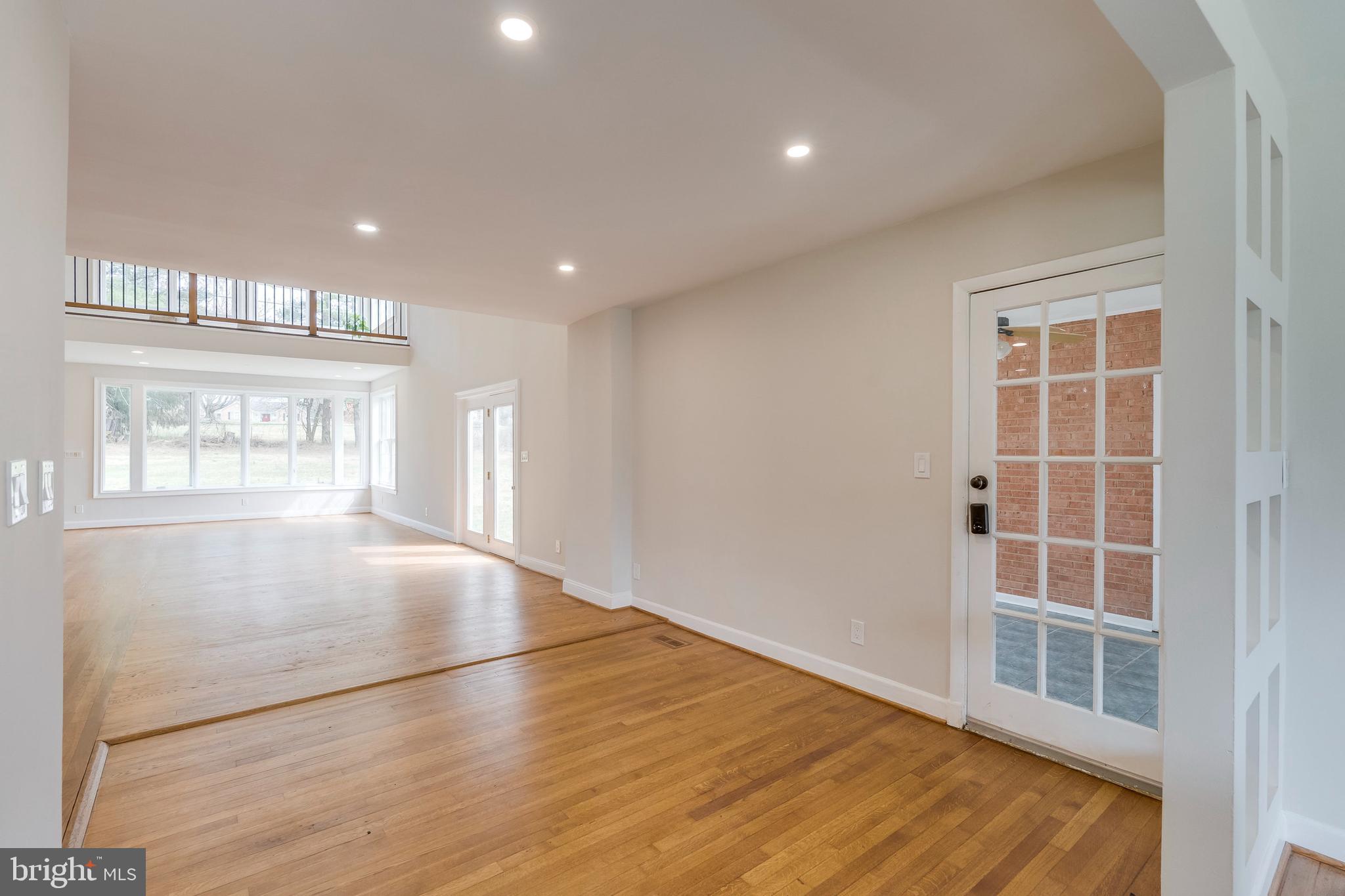 15001 Peach Orchard Road Silver Spring, MD 20905 - Photo 15 of 63 an empty room with wooden floor and windows