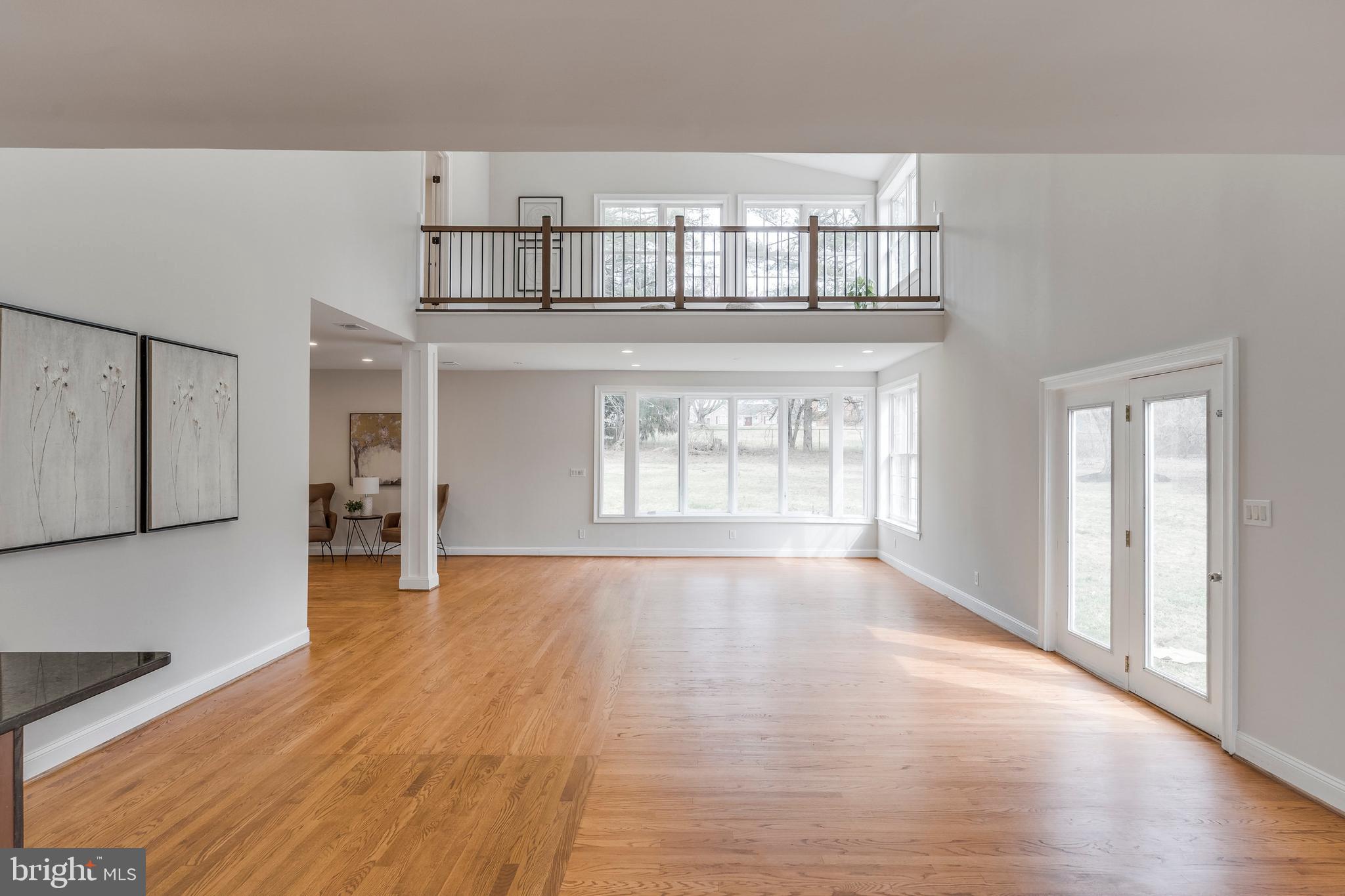 15001 Peach Orchard Road Silver Spring, MD 20905 - Photo 23 of 63 a view of an empty room with wooden floor and a window