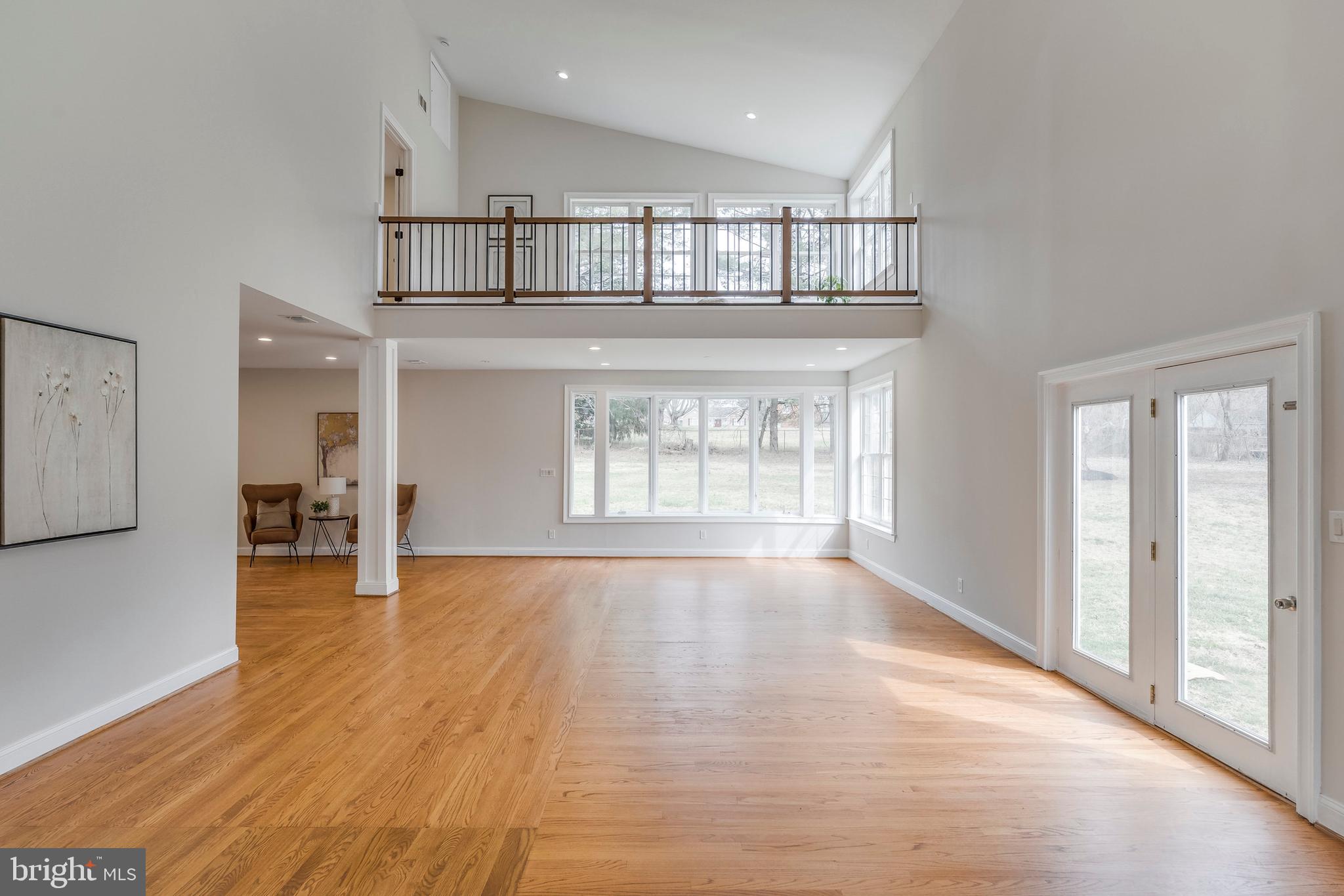 15001 Peach Orchard Road Silver Spring, MD 20905 - Photo 24 of 63 a view of an empty room with wooden floor and kitchen