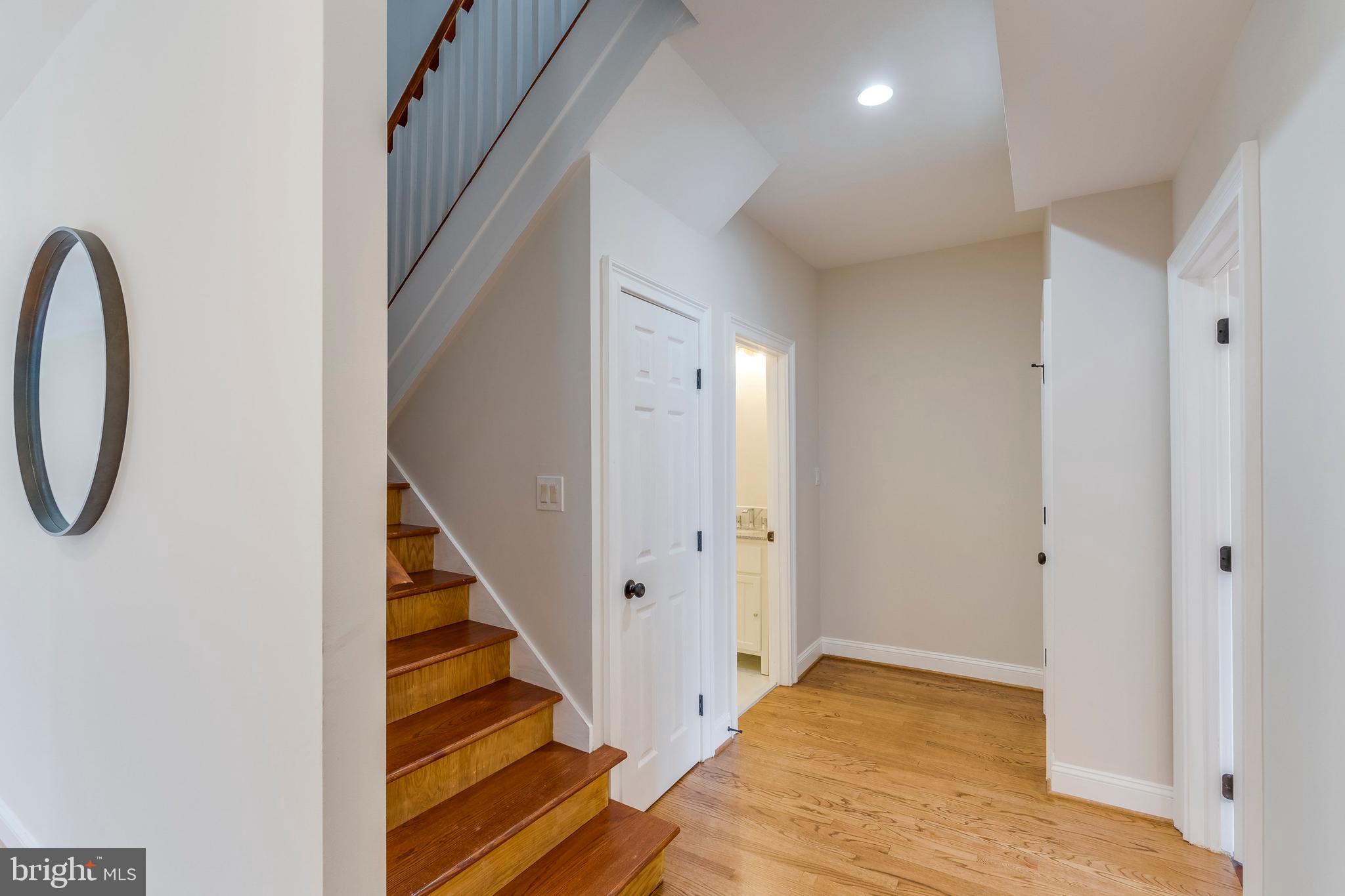 15001 Peach Orchard Road Silver Spring, MD 20905 - Photo 25 of 63 a view of a hallway with wooden floor and staircase