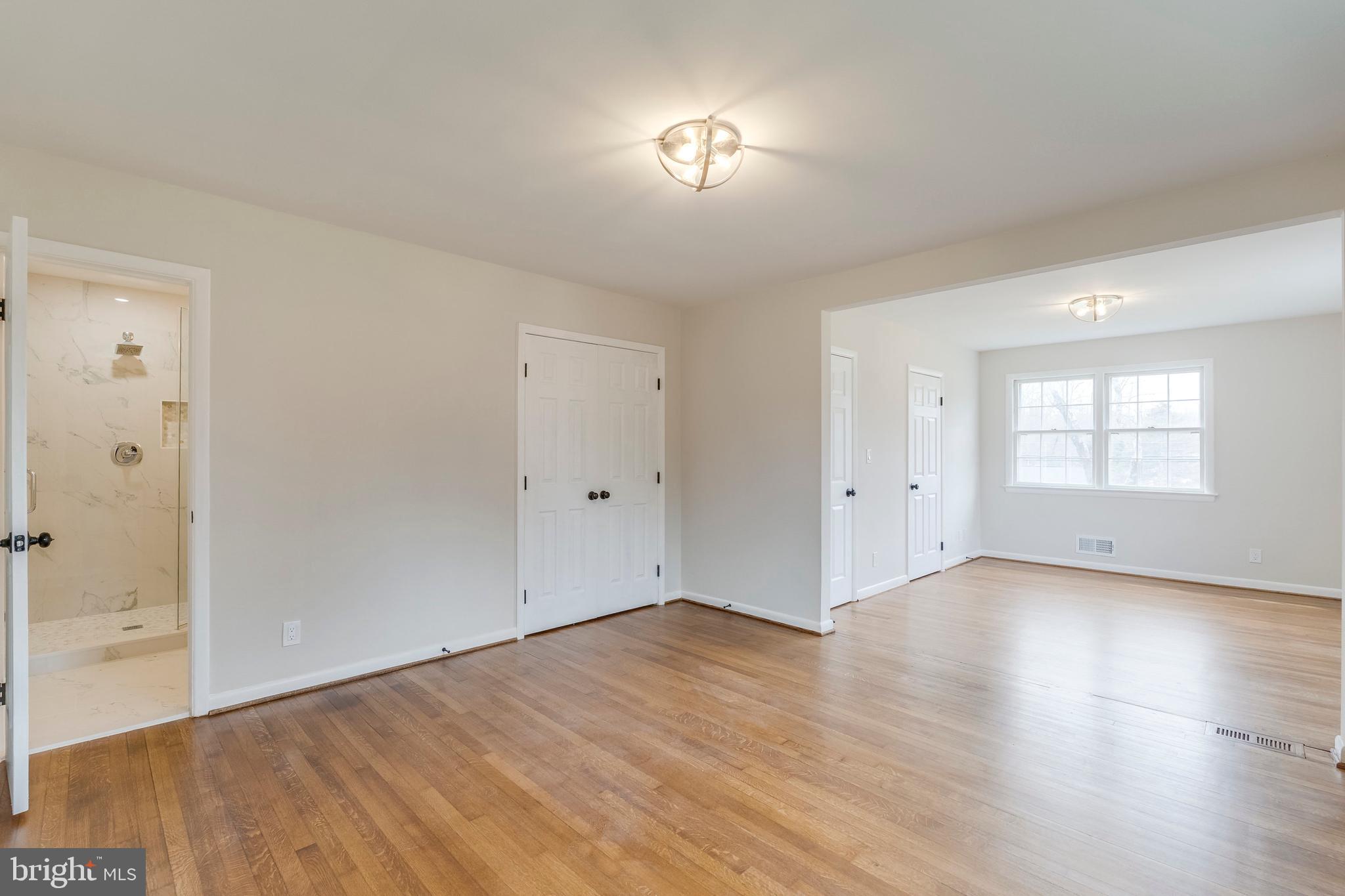 15001 Peach Orchard Road Silver Spring, MD 20905 - Photo 33 of 63 an empty room with wooden floor and windows