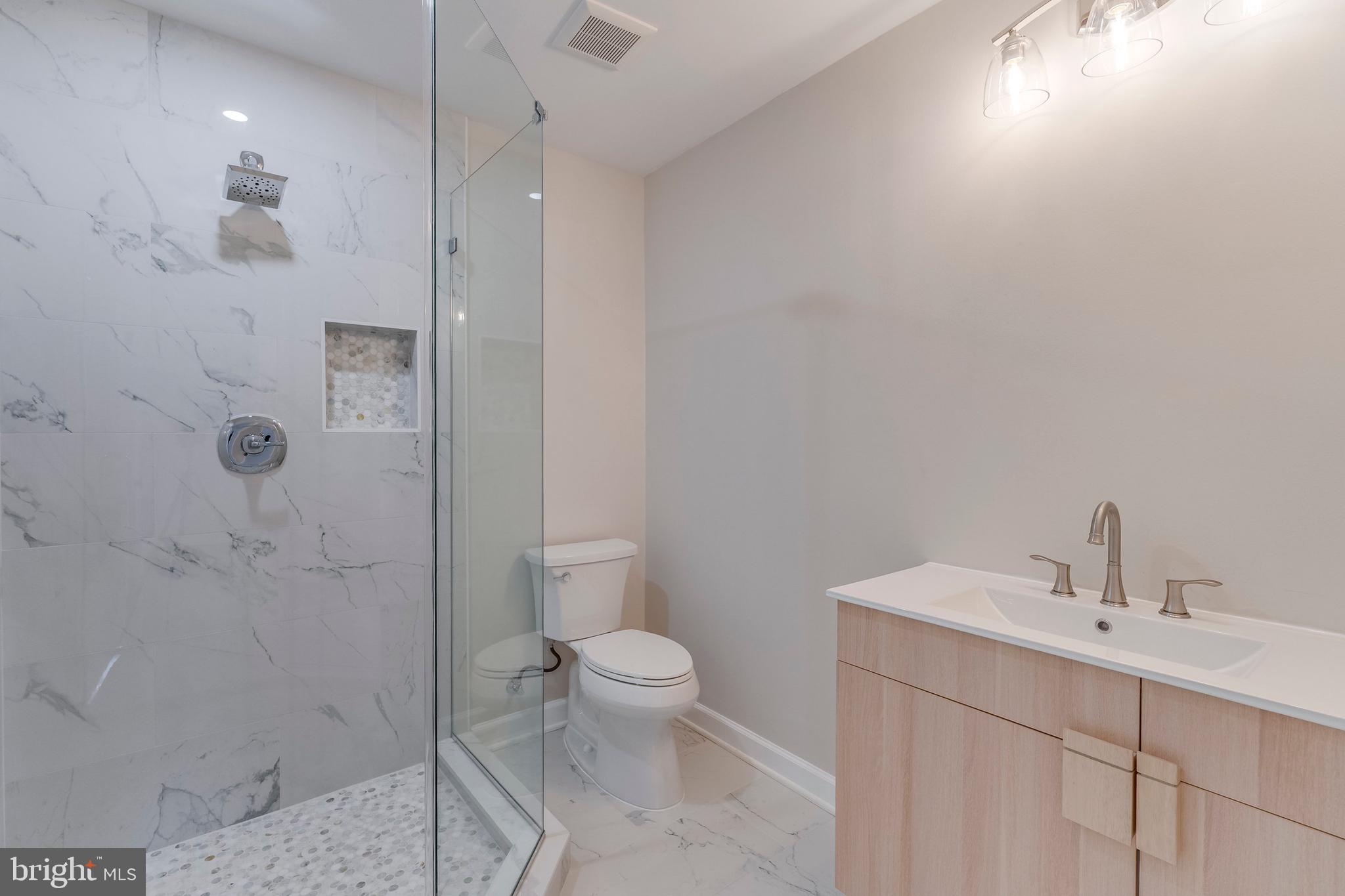 15001 Peach Orchard Road Silver Spring, MD 20905 - Photo 36 of 63 a bathroom with a sink a toilet and shower