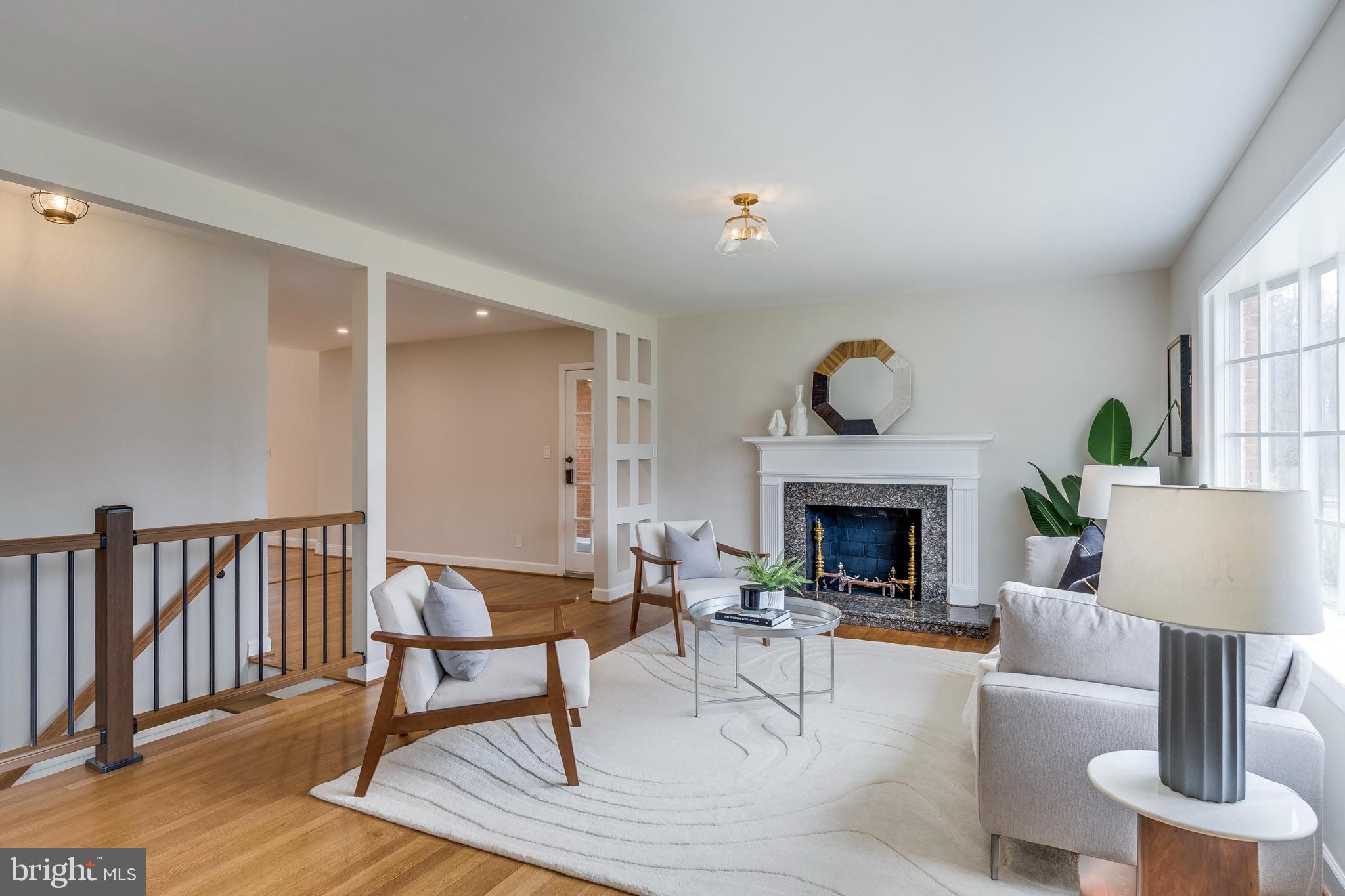 15001 Peach Orchard Road Silver Spring, MD 20905 - Photo 4 of 63 a living room with furniture a fireplace and a table