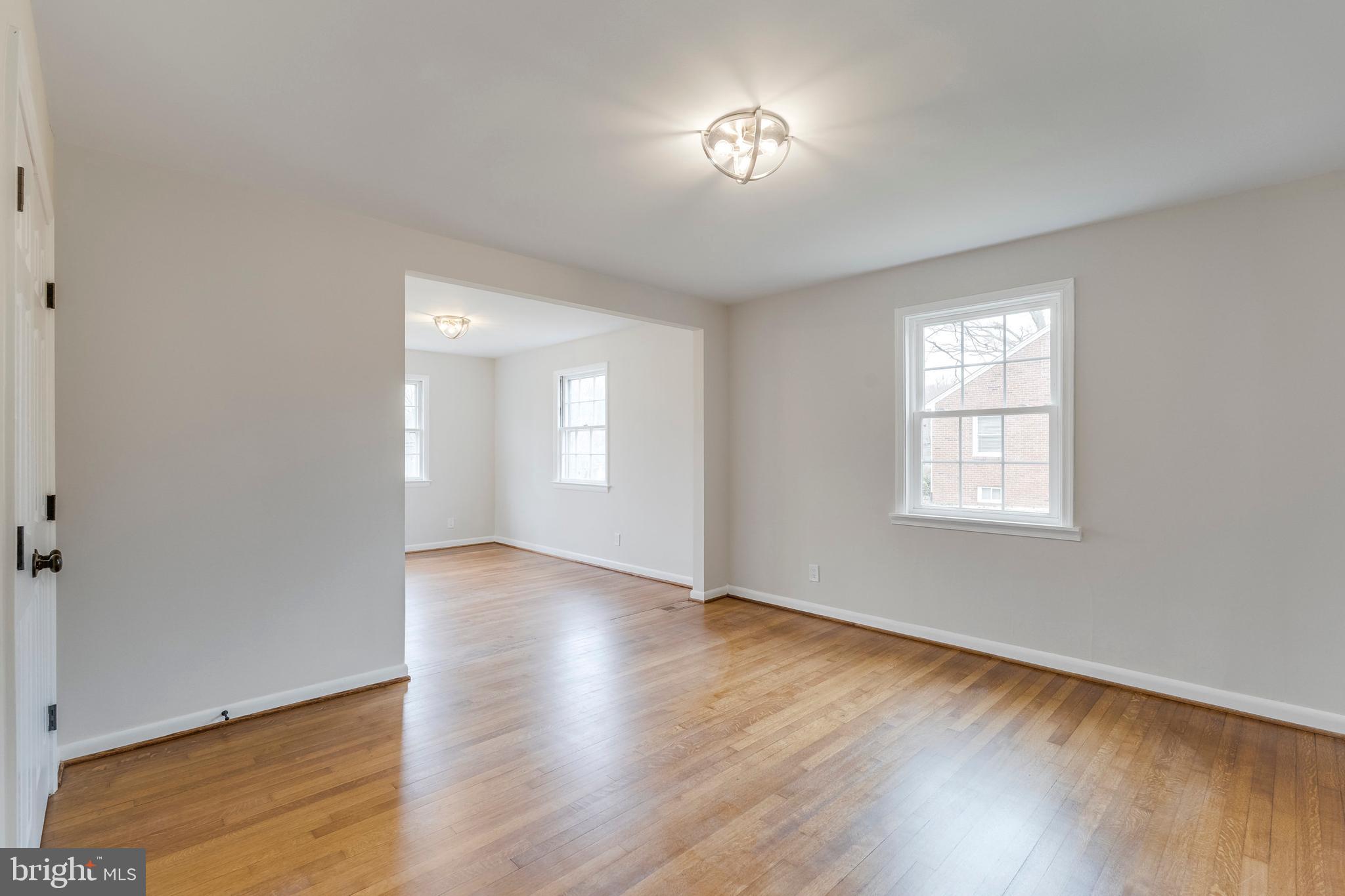 15001 Peach Orchard Road Silver Spring, MD 20905 - Photo 46 of 63 an empty room with wooden floor and windows
