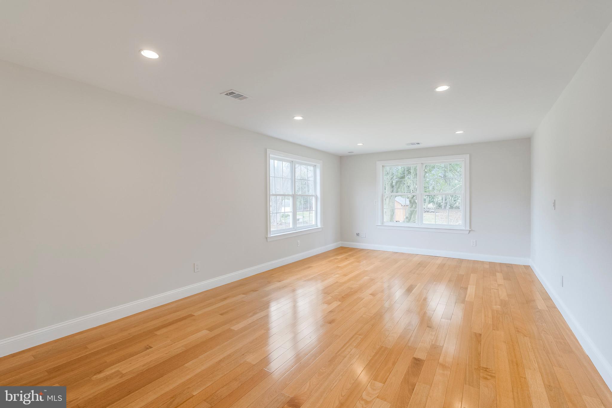 15001 Peach Orchard Road Silver Spring, MD 20905 - Photo 47 of 63 an empty room with wooden floor and windows