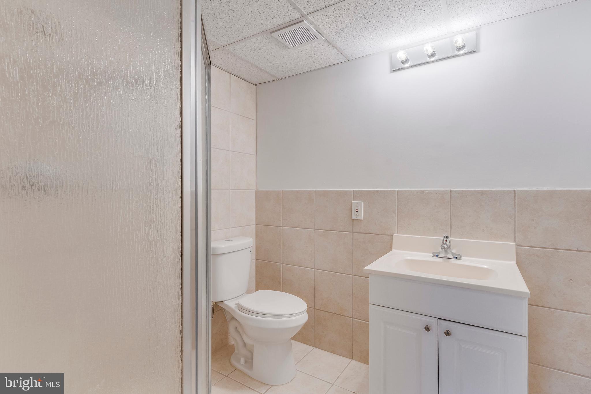 15001 Peach Orchard Road Silver Spring, MD 20905 - Photo 56 of 63 a bathroom with a toilet sink and mirror