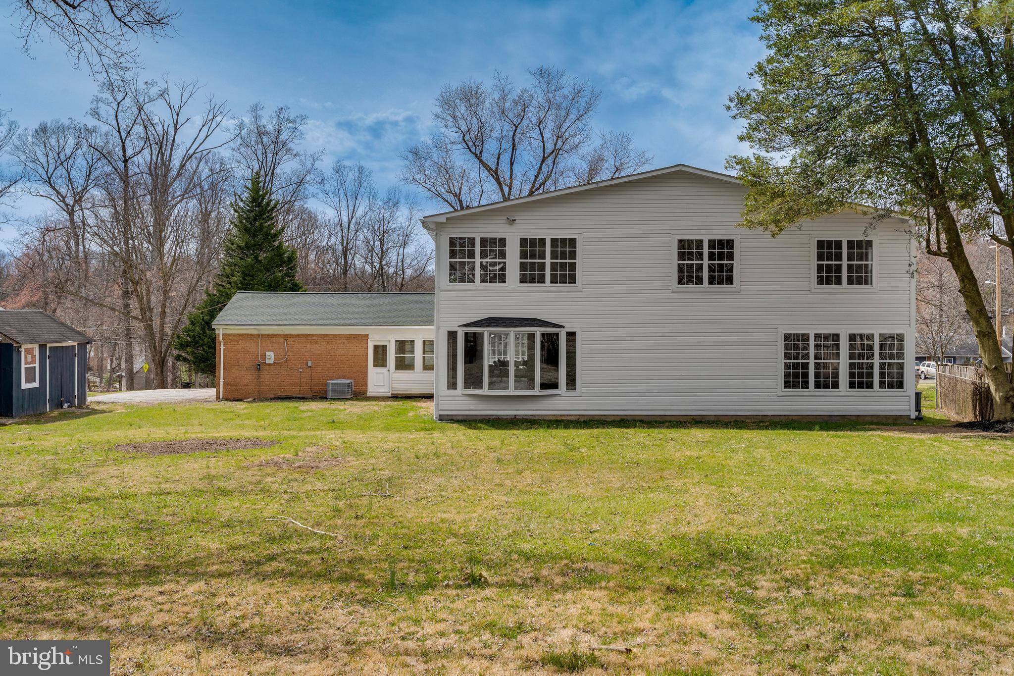 15001 Peach Orchard Road Silver Spring, MD 20905 - Photo 63 of 63 a front view of house with yard and trees in the background