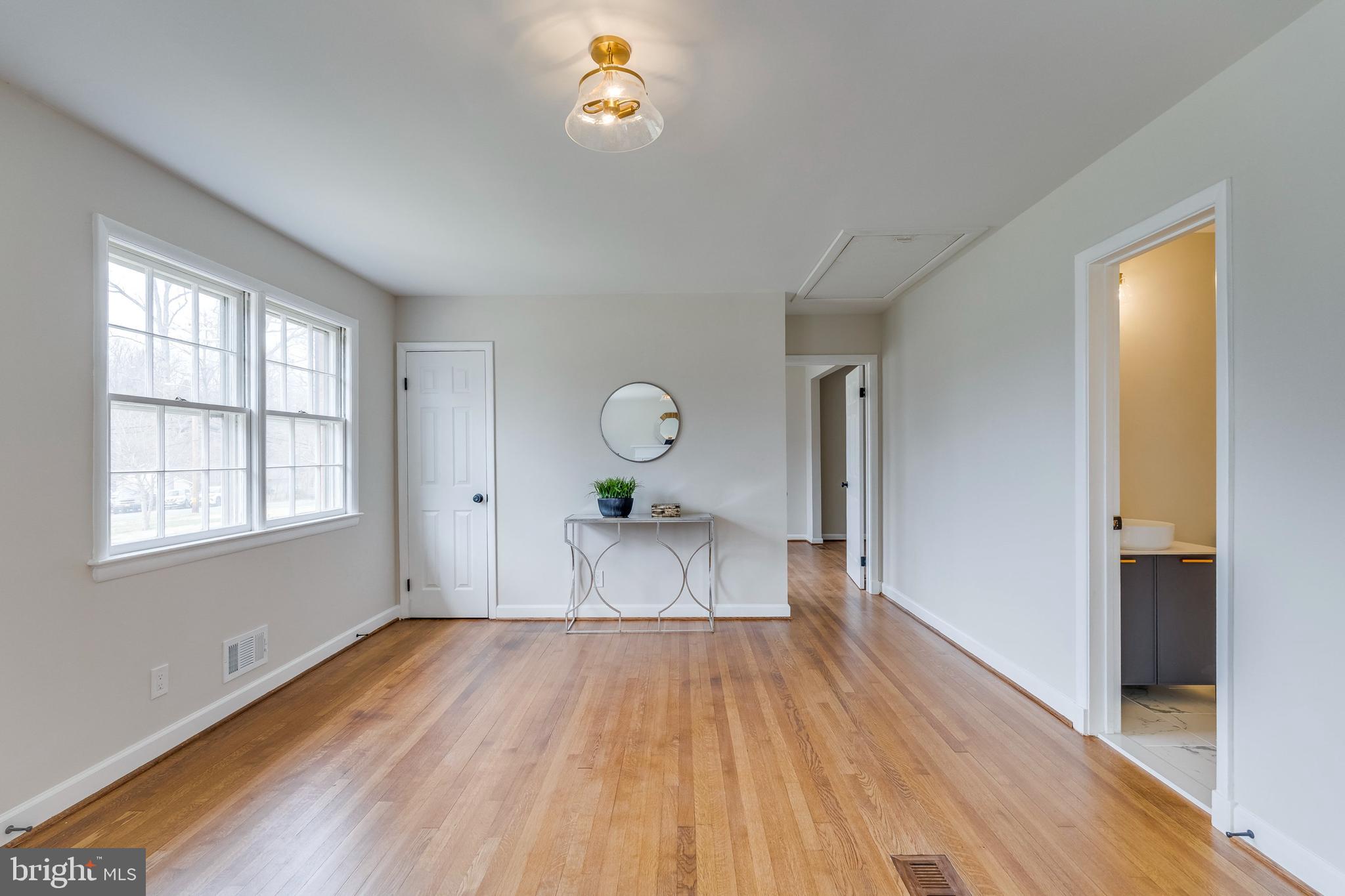15001 Peach Orchard Road Silver Spring, MD 20905 - Photo 9 of 63 a view of empty room with wooden floor and fan