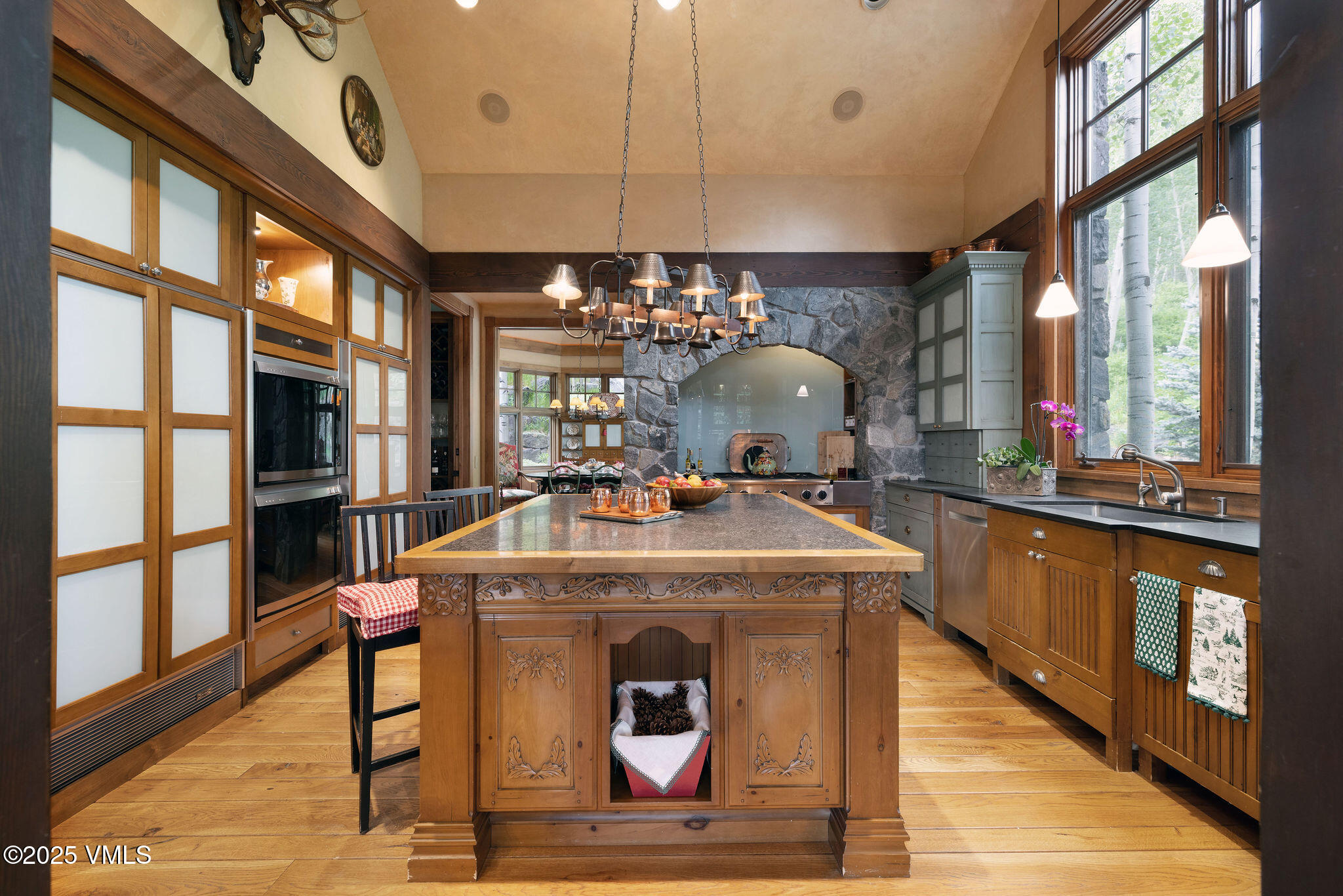 780 Potato Patch Drive Vail, CO 81657 - Photo 4 of 26 a view of a kitchen with stainless steel appliances granite countertop a stove and a large window
