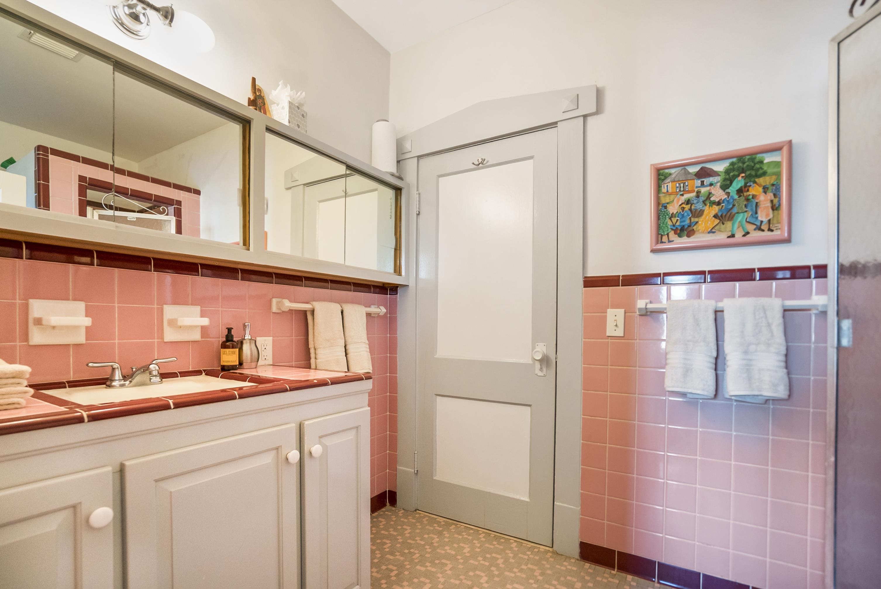 131 Washington Street St. Augustine, FL 32084 - Photo 13 of 33 a bathroom with a sink a mirror and a shower
