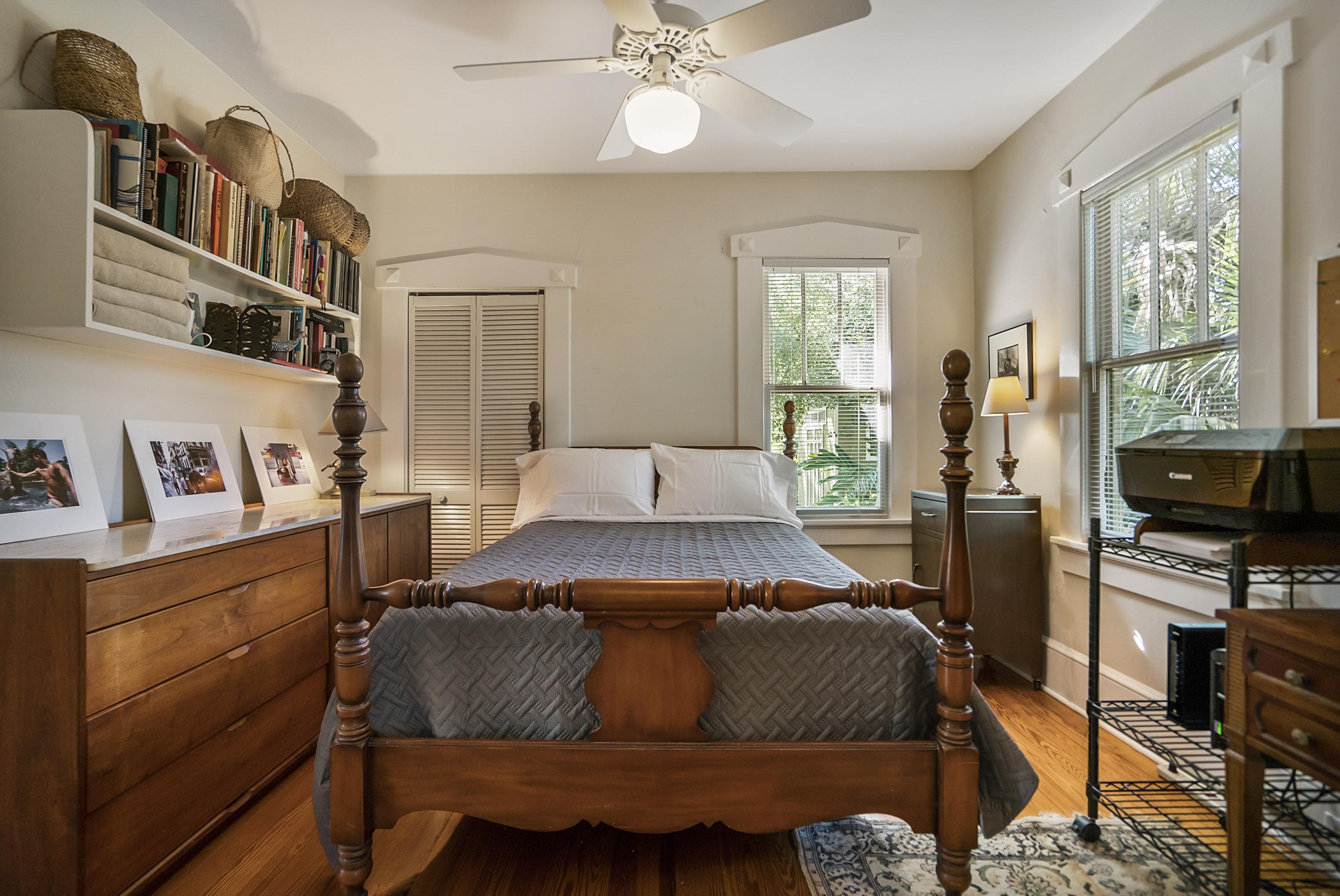 131 Washington Street St. Augustine, FL 32084 - Photo 14 of 33 a bedroom with a bed and a flat tv screen on the dresser
