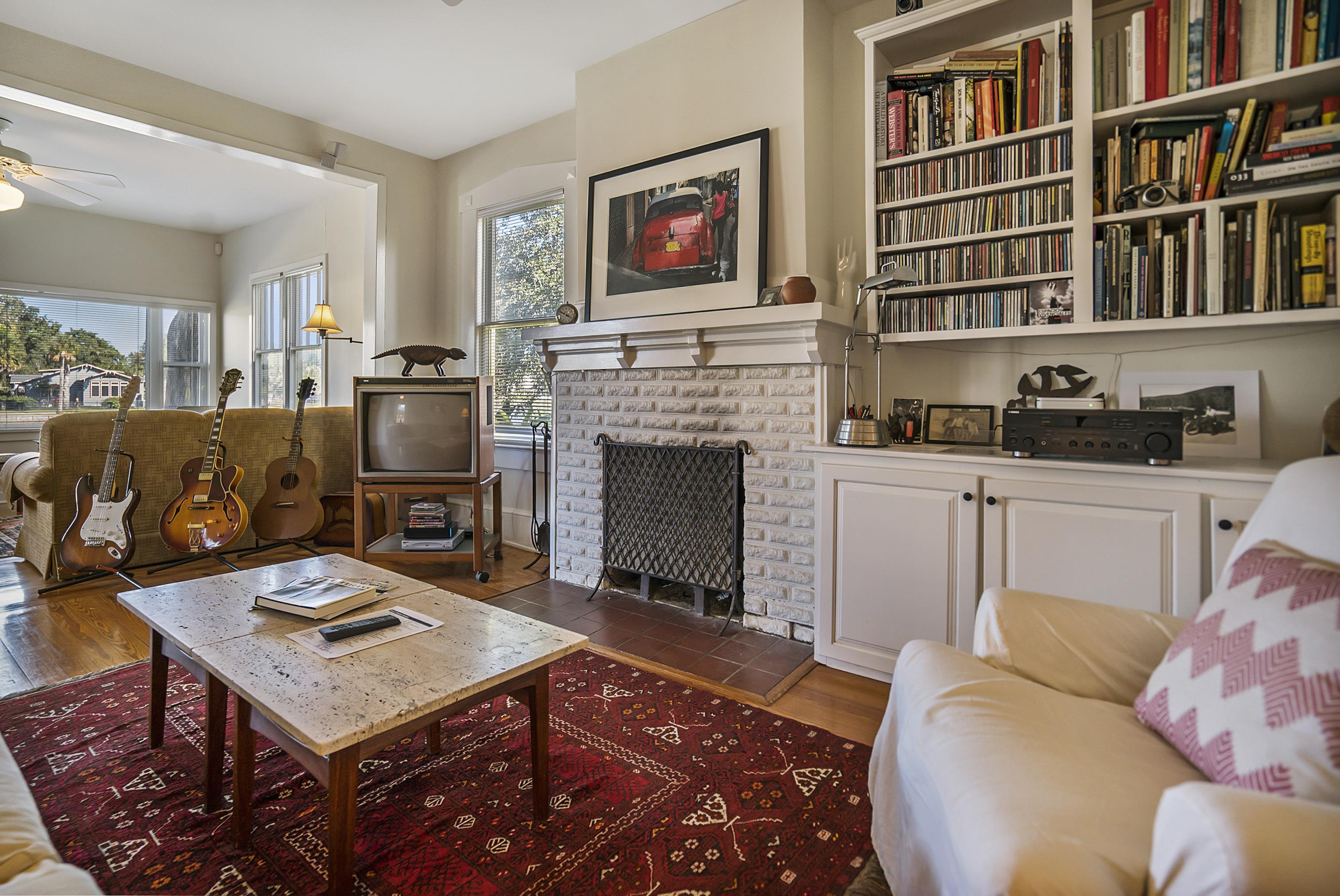 131 Washington Street St. Augustine, FL 32084 - Photo 2 of 33 a living room with furniture a rug and a fireplace