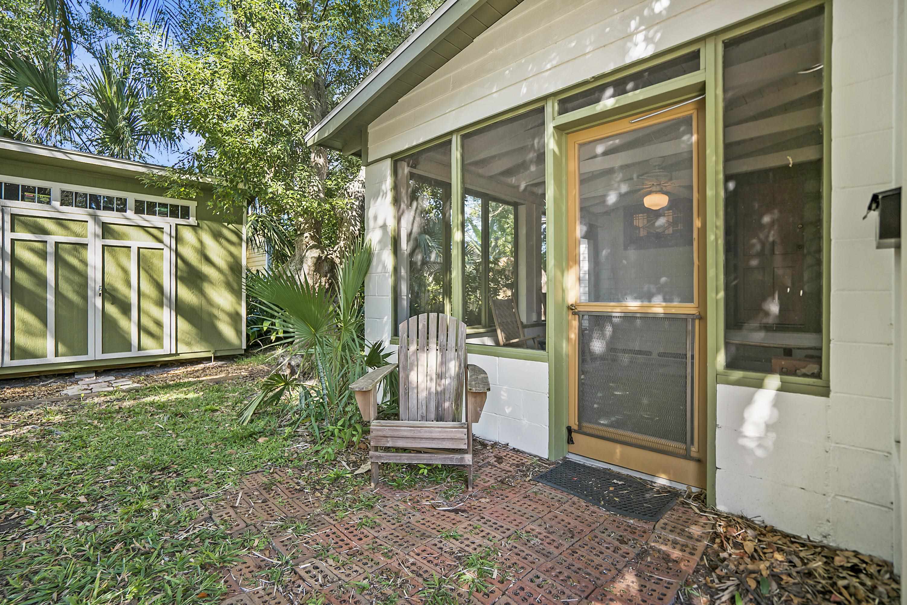 131 Washington Street St. Augustine, FL 32084 - Photo 25 of 33 a porch with a bench and floor to ceiling window