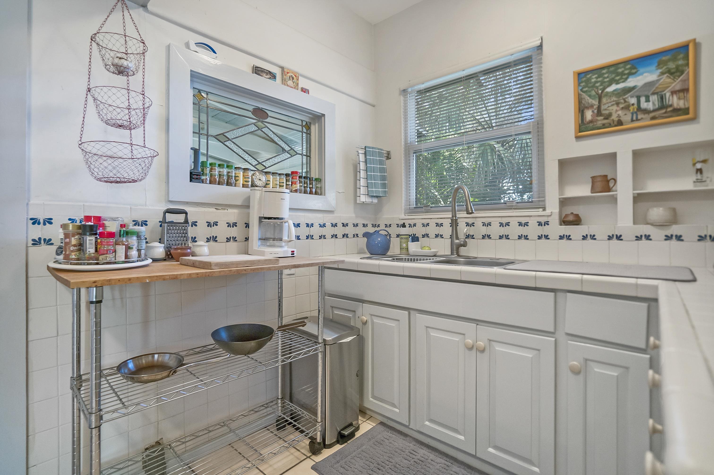 131 Washington Street St. Augustine, FL 32084 - Photo 6 of 33 a kitchen with a sink cabinets and a window