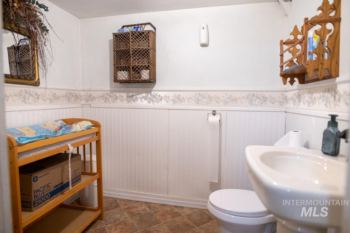 736 East Main Street Weiser, ID 83672 - Photo 15 of 33 Bathroom featuring a wainscoted wall and toilet