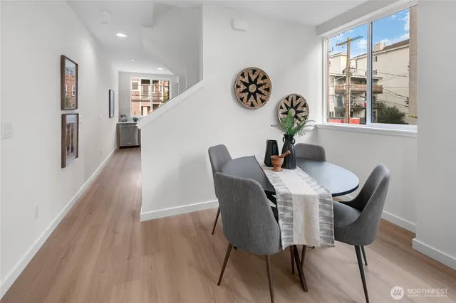 a view of a dining room with furniture and wooden floor