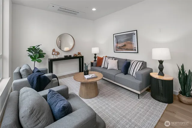 a living room with furniture and a mirror