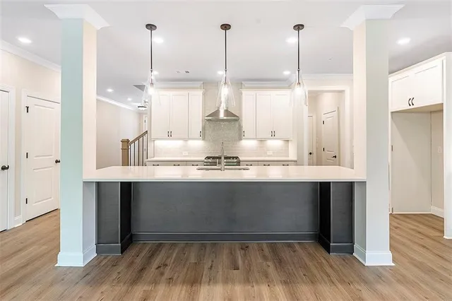 a view of a kitchen with stainless steel appliances granite countertop wooden floors