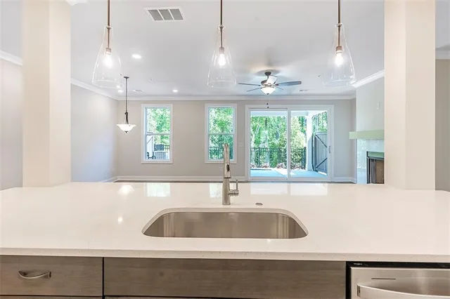 a kitchen with a sink cabinets and a large window