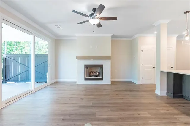 a view of an empty room with a fireplace and a window