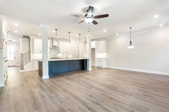 a view of a kitchen with wooden floor and a kitchen