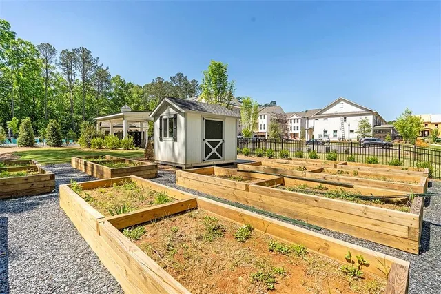 a view of a patio with table and chairs potted plants and a palm tree