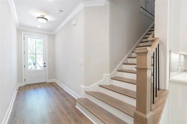 a view of entryway and hall with wooden floor