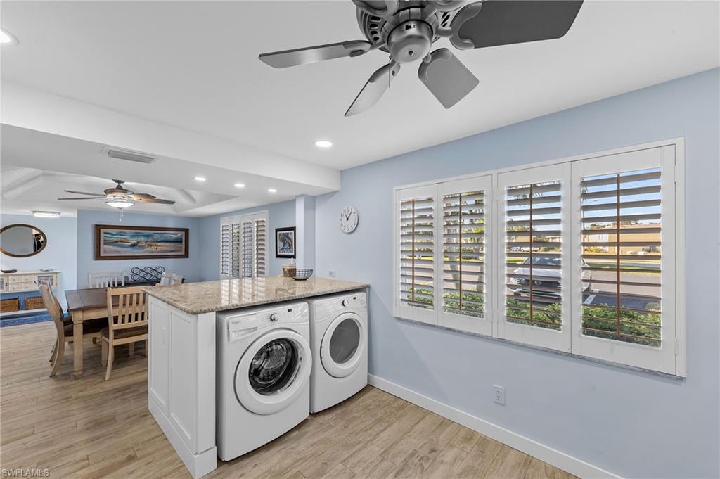 105 Penny Lane, Unit 5 Naples, FL 34112 - Photo 12 of 50 a view of a kitchen with a stove cabinets and wooden floor