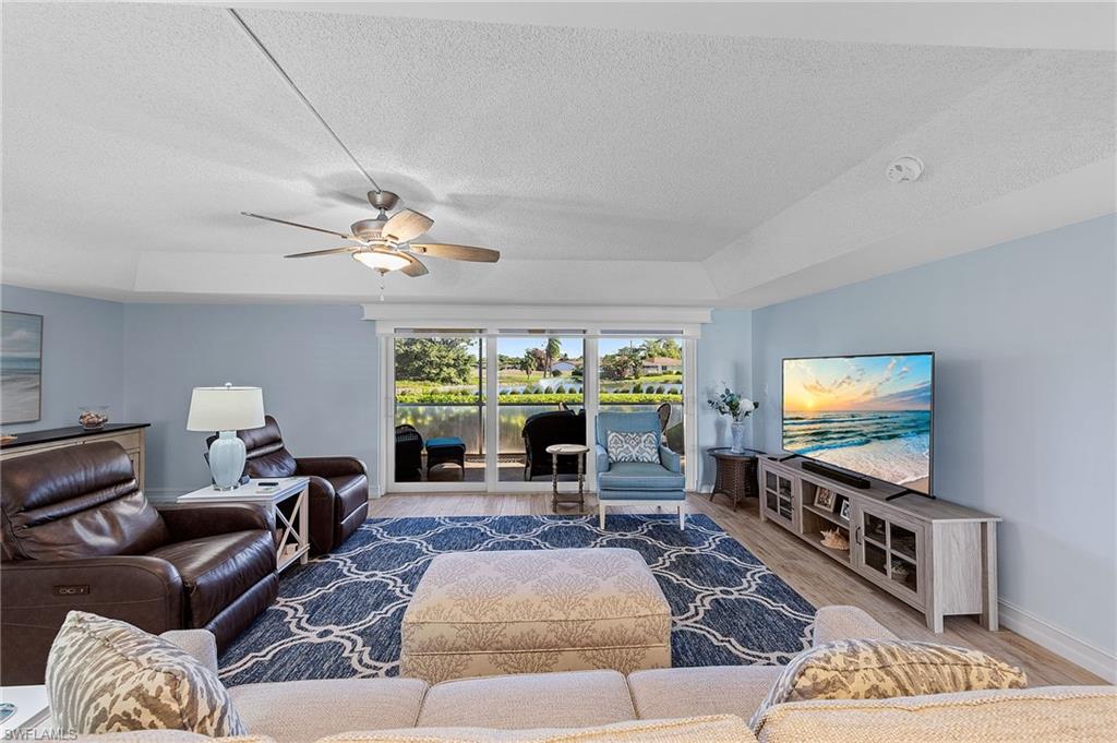 105 Penny Lane, Unit 5 Naples, FL 34112 - Photo 15 of 50 a living room with furniture and a flat screen tv