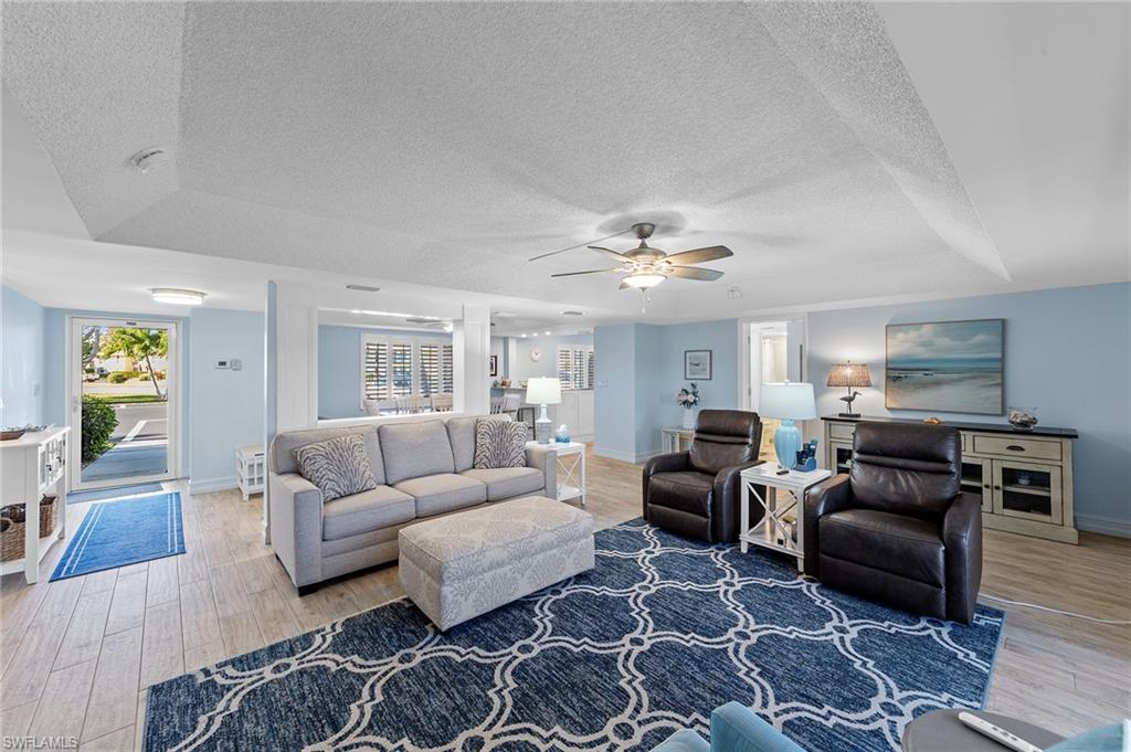 105 Penny Lane, Unit 5 Naples, FL 34112 - Photo 17 of 50 a living room with furniture and wooden floor