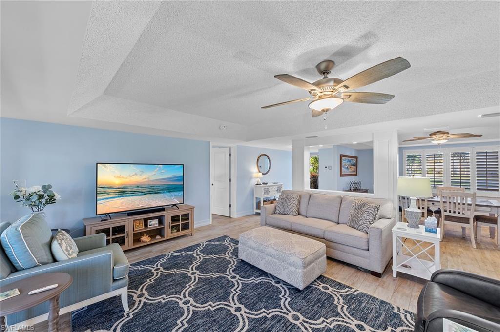 105 Penny Lane, Unit 5 Naples, FL 34112 - Photo 18 of 50 a living room with furniture and a flat screen tv