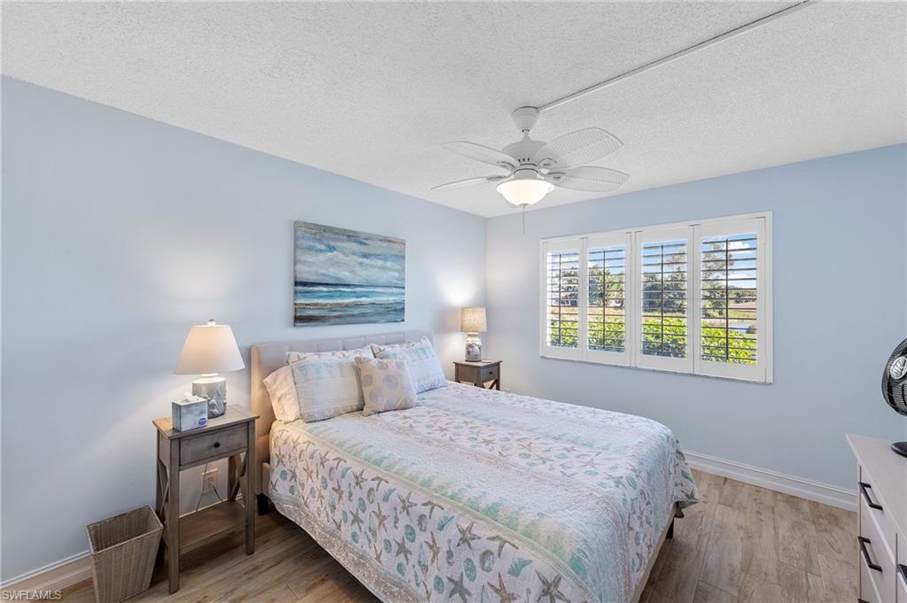 105 Penny Lane, Unit 5 Naples, FL 34112 - Photo 19 of 50 a bedroom with a bed and a window