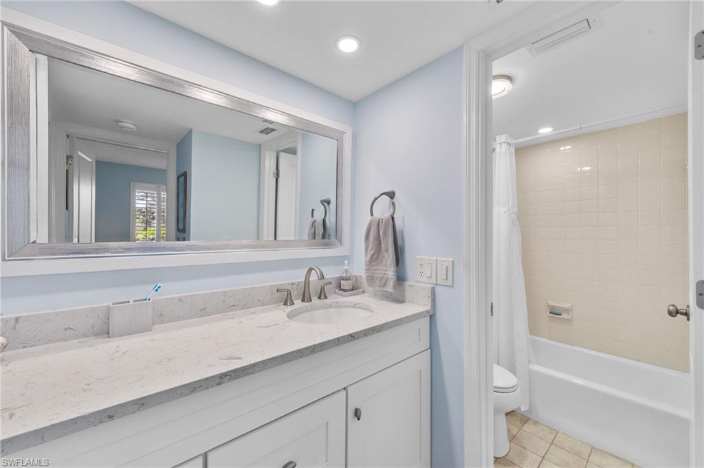 105 Penny Lane, Unit 5 Naples, FL 34112 - Photo 21 of 50 a bathroom with a tub sink and mirror