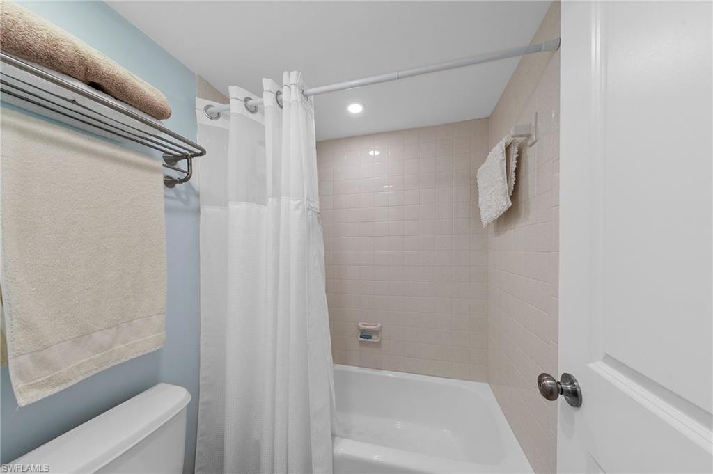 105 Penny Lane, Unit 5 Naples, FL 34112 - Photo 22 of 50 a bathroom with a shower and a tub