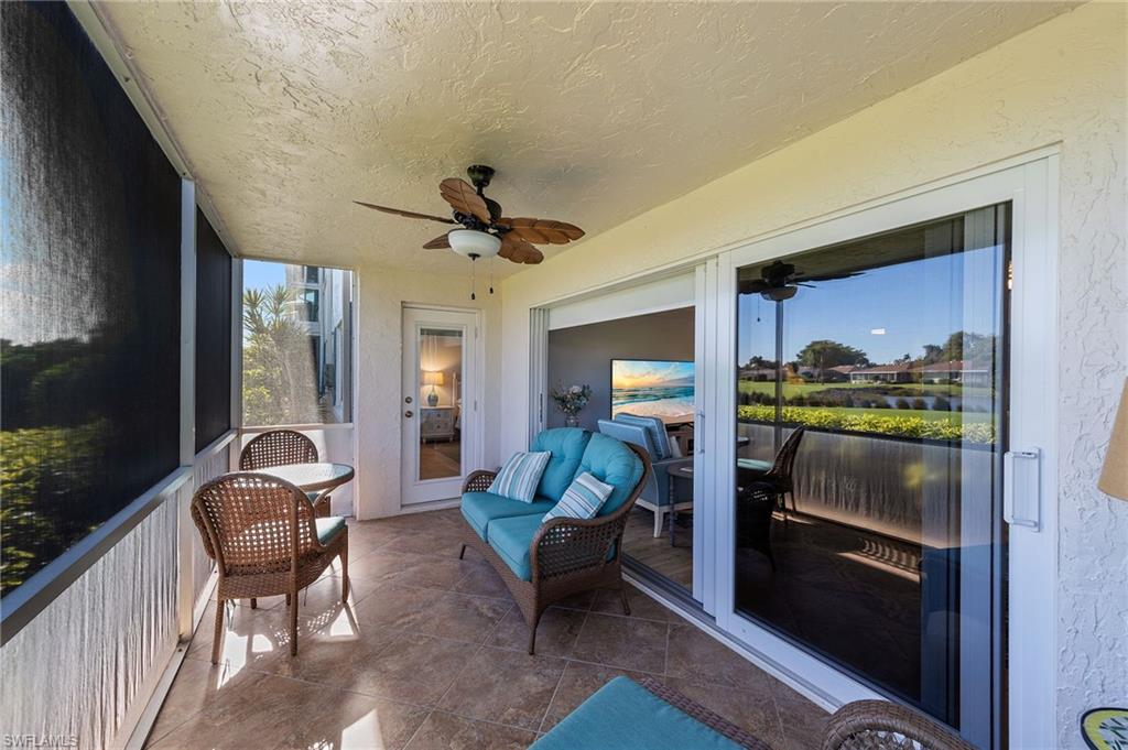 105 Penny Lane, Unit 5 Naples, FL 34112 - Photo 31 of 50 a living room with furniture and a floor to ceiling window