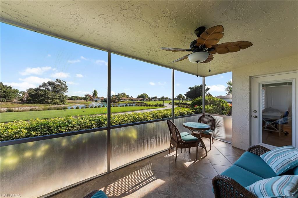 105 Penny Lane, Unit 5 Naples, FL 34112 - Photo 32 of 50 a view of a chairs and table in patio with a lake view