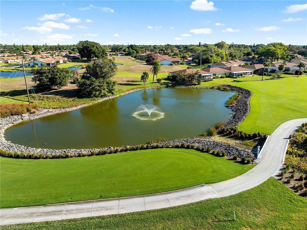 105 Penny Lane, Unit 5 Naples, FL 34112 - Photo 40 of 50 an aerial view of a house with a swimming pool outdoor seating and outdoor seating