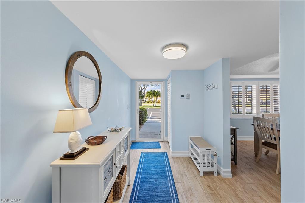 105 Penny Lane, Unit 5 Naples, FL 34112 - Photo 5 of 50 a view of a livingroom with furniture and wooden floor
