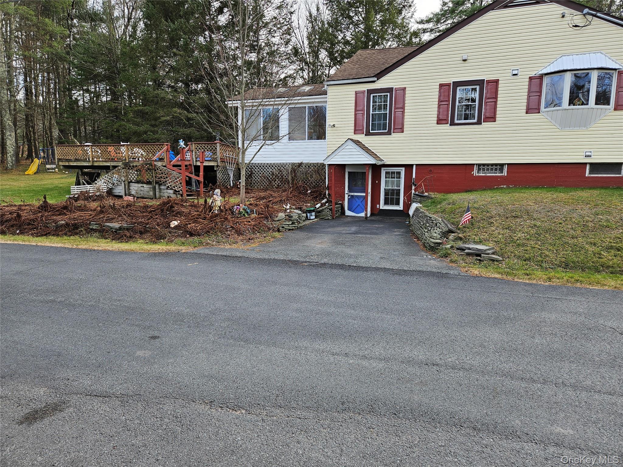 3624 State Rte 55 Kauneonga Lake, NY 12749 - Photo 9 of 48 a front view of a house with a yard and garage