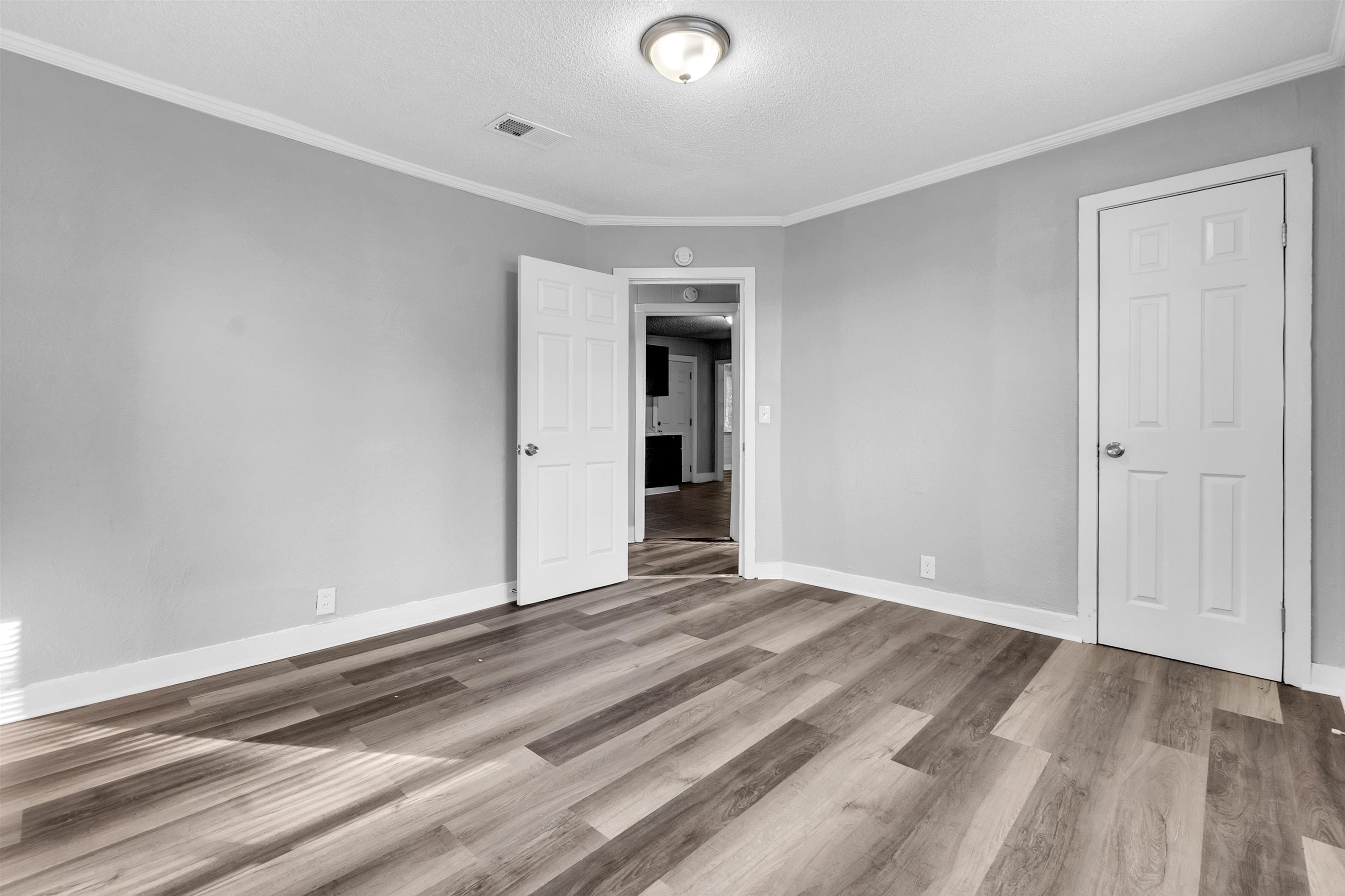 2442 Manchester Road Memphis, TN 38114 - Photo 13 of 22 a view of an empty room with wooden floor and closet