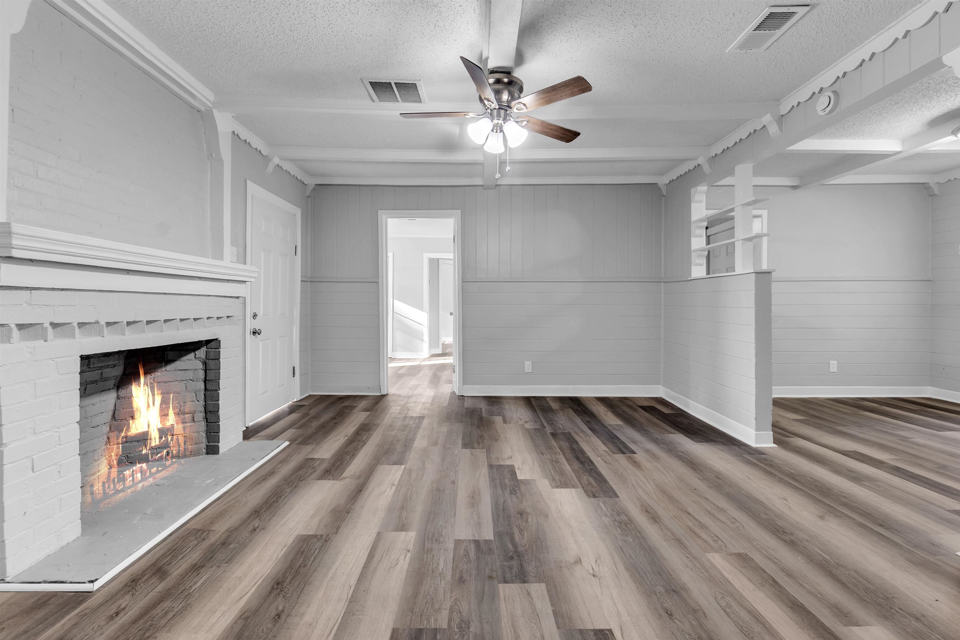 2442 Manchester Road Memphis, TN 38114 - Photo 5 of 22 wooden floor in an empty room with a fireplace