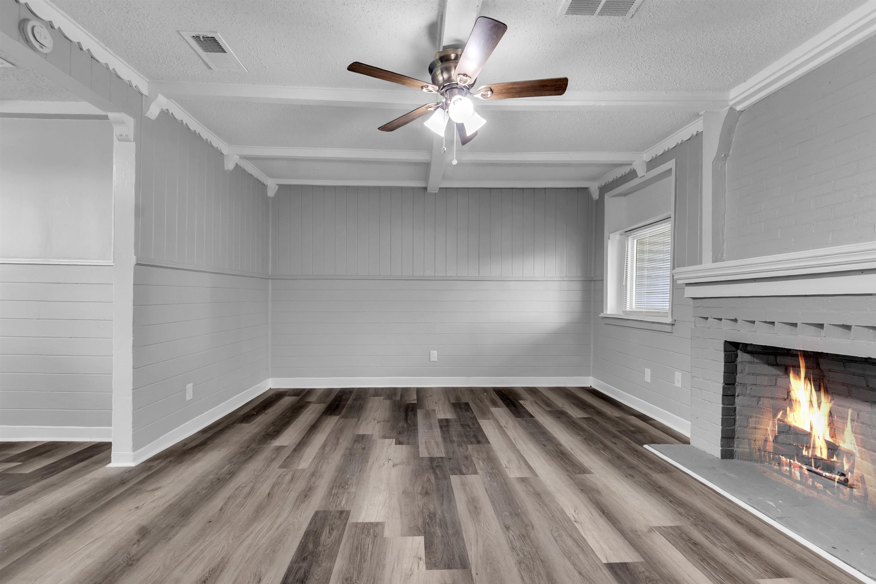 2442 Manchester Road Memphis, TN 38114 - Photo 9 of 22 wooden floor in an empty room with a fireplace