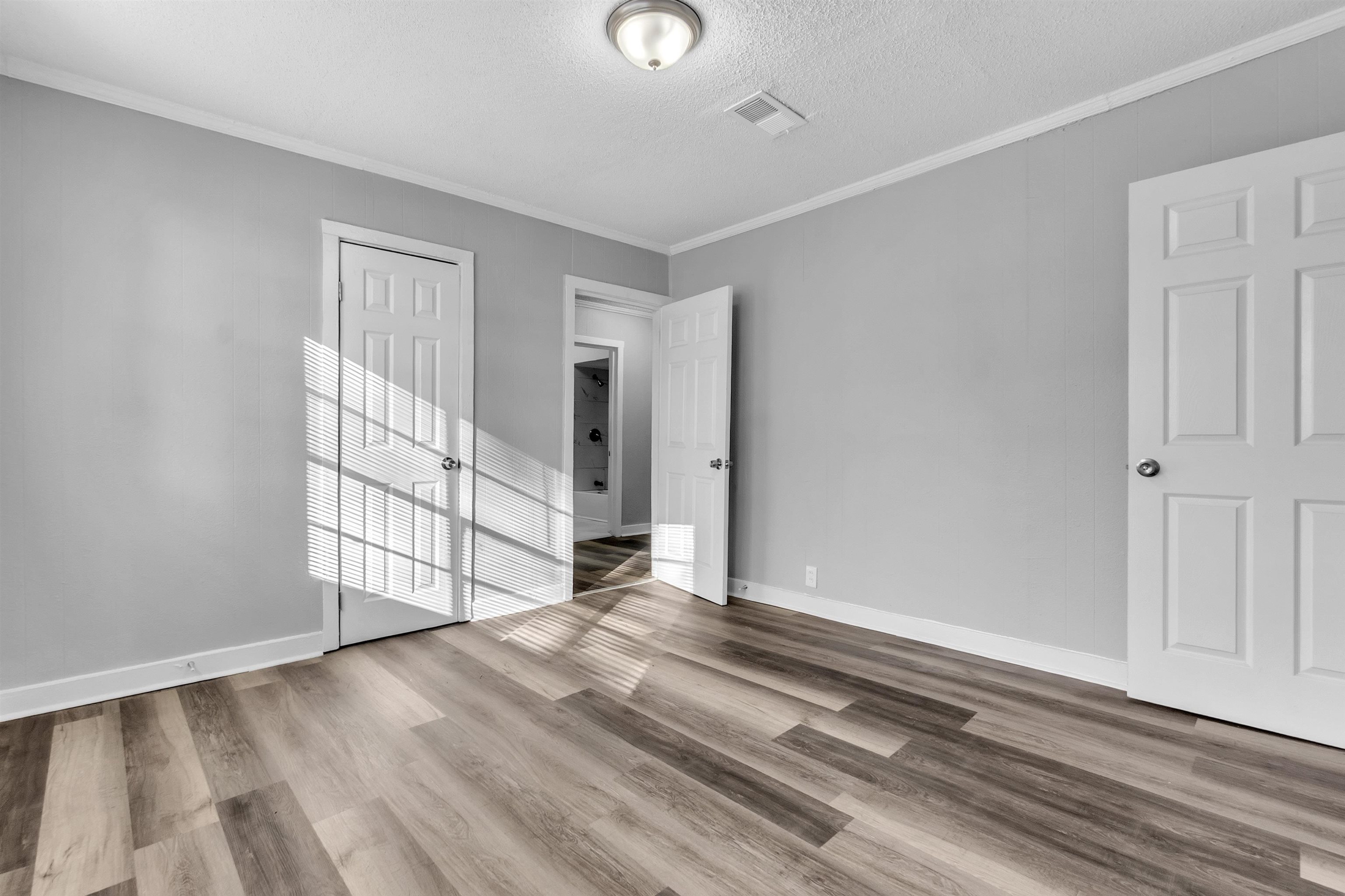 2442 Manchester Road Memphis, TN 38114 - Photo 10 of 22 a view of empty room with wooden floor and fan