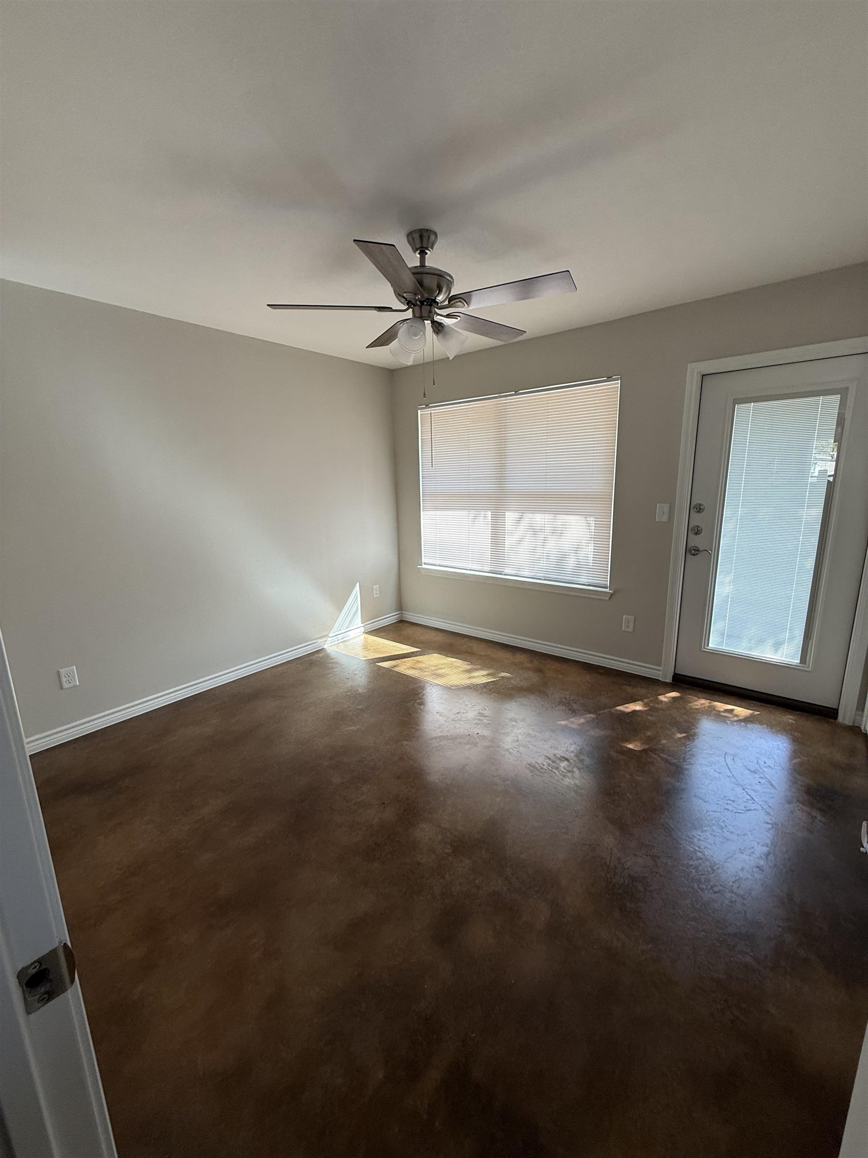 1704 East 3rd Street Lampasas, TX 76550 - Photo 9 of 11 an empty room with wooden floor and windows