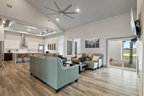 a living room with furniture and a wooden floor