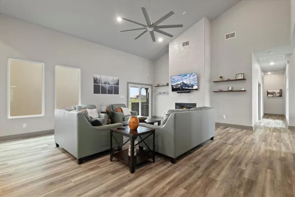 a living room with furniture and a wooden floor